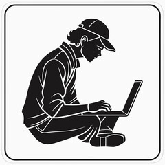 Silhouette of a person wearing a baseball cap sitting cross legged and working on a laptop computer with focused expression