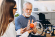© Maria Vitkovska - Senior man doing rehabilitation exercises with doctor