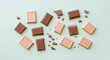 © Polina - Assorted chocolate pieces on pastel mint background for sweet treat concept