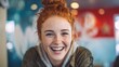 © mila103 - A young woman with vibrant red hair and freckles beams with happiness while sitting in a colorful cafe. Her casual attire and cheerful expression create an inviting atmosphere.