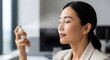© Becheer - Professional woman using cooling facial mist for hot flash relief.