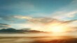 © mila103 - A stunning sunset casts warm colors across the sky with mist rolling over distant mountains and a serene landscape below. The scene is peaceful and calming at twilight.