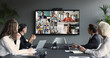 © fizkes - Group of multinational businesspeople, displayed on screen, engaged in videocall