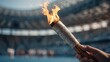 © Stitch - Exciting moment of a person holding a flaming torch in a large stadium during a special event celebration