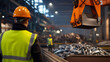 © twc - Industrial worker overseeing material handling with overhead crane in a factory setting. Safety first in manufacturing process.