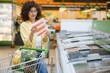 © Serhii - Customer choosing frozen fish in supermarket freezer section