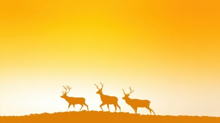 Wall Mural - Silhouette of Three Deer Grazing Against a Golden Sunset Sky with Warm Hues and Tranquil Atmosphere in a Natural Wildlife Setting