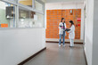 © STOCKEROcr - Two female scientists discussing in laboratory hallway