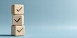 © Budi - Three light beige wooden cubes stacked vertically, each with a checkmark symbol.  A pale, light-blue background creates a minimalist, clean aesthetic
