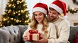 © Hamid - A happy couple seated on a plush gray sofa in a cozy living room decorated for Christmas. Christmas, Christmas Tree, Merry Christmas, Christmas Background, Christmas Lights