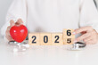 © Jo Panuwat D - 2025 end year to Happy New Year 2026 with Stethoscope of doctor and heart shape on table. health care, Insurance, Wellness and medical concepts