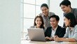 © HecoPhoto - Happy Asian Business Team Collaborating on Laptop in Modern Office