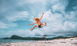 © Aboltin - Energetic man jumping high in air on tropical beach, expressing freedom and pure joy of summer vacation. Wearing straw hat and sunglasses, enjoying moment of sunny holiday.