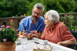 © Halfpoint - Nurse helping elderly woman measure blood sugar with glucometer.