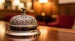 © cattar - Elegant hotel service bell on a polished wooden desk offering discreet customer assistance