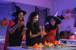 © crizzystudio - Young women celebrating halloween party at home