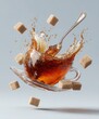 © Lady O - A cup of tea is floating in the air, with splashes and a spoon on a white background. there are sugar cubes inside the teacup.