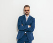 © Viorel Sima - confident businessman with sunglasses crossing arms and looking forward
