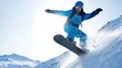 © David Zarzosa - Snowboarder jumping on snowy slope in winter mountains, extreme sport athlete performing trick in dynamic action under bright sunlight.