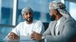 © udin - Authentic Middle Eastern Businessman Meeting in Modern Office, Traditional Dress Discussion. Ai Generated Images