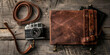 © Zaid - Vintage leather camera and journal laid on rustic wooden surface
