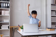 © Phimwilai - Happy asian student celebrating success with laptop at home