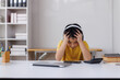 © Phimwilai - Asian student feeling stressed while studying online at home