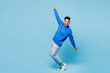 © ViDi Studio - Full body young man of African American ethnicity wear sweatshirt casual clothes standing on toes dancing lean back have fun spreading hands isolated on plain pastel light blue cyan background studio.