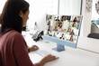 © fizkes - Woman participating in videoconference on modern desktop computer in office