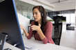 © fizkes - Woman engaged in online meeting or customer support task