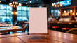 © Lauren - Mock up Label the blank menu frame in Bar restaurant ,Stand for booklets with white sheets paper acrylic tent card on wooden table cafeteria blurred background can inserting the text of the customer.