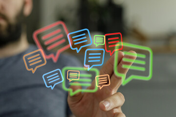 Abstract image of a man's hand touching virtual chat bubbles symbolizing digital communication and connection.