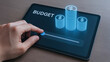 © newlifestock - Budget planning goal 2026 financial tablet coin stack slider hand controlling money growth optimistic