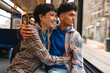 © Iryna - Young couple embracing on public transport looking out window in the City during daytime