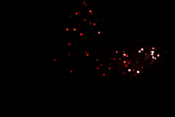 Wall Mural - Red blurred bokeh lights on black background. Glitter sparkle confetti for celebrate. Overlay for your design