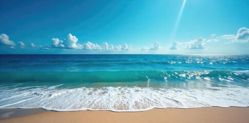 Wall Mural - vast expanse of deep blue ocean, waves crashing on a sandy shore, sunlight reflecting on the water's