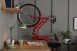 © New Africa - Red bicycle and stylish furniture near grey wall indoors