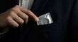 © Volha - Man retrieving condom from pocket while wearing a suit