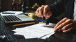 © Sumi - Legal professional's hands applying an official rubber stamp onto important business paperwork, signifying authorization and approval on a dark wooden desk