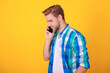 © be free - Modern communication. Man speak on phone isolated on yellow. Millennial man has phone call. Man talk on cellphone. Phone call. Mobile connection. Guy with coffee. Student lifestyle