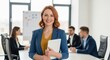 © MST - Smiling woman leading business meeting with team members in conference room