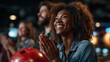 © George - Excitement builds as friends cheer on the slow-motion moments at a lively bowling alley