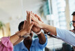 © Lumos sp - A portrait of young businesspeople celebrating with high five in the office