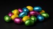 © hobi - Pile of colorful foil wrapped chocolate easter eggs on black background