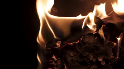 Burning paper, glowing edge of paper on a black background. Mockup for your logo. Wide angle horizontal wallpaper or web banner. flame effects for overlay designs or screen blending mode to make high.