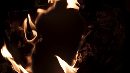 Burning paper, glowing edge of paper on a black background. Mockup for your logo. Wide angle horizontal wallpaper or web banner. flame effects for overlay designs or screen blending mode to make high.