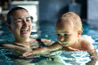 © puhimec - Baby floating on water in mothers hands at spa pool. Learning to swim.