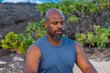 © Solomon - A serene portrait of a Black male in meditation, surrounded by tropical greens and volcanic textures. Captures mindfulness, balance, and mental clarity—ideal for wellness branding.