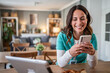 © Migma_Agency - Smiling female nurse relaxing with smartphone at home