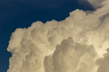 Wall Mural - Clouds in the blue sky before a thunderstorm. Toned.